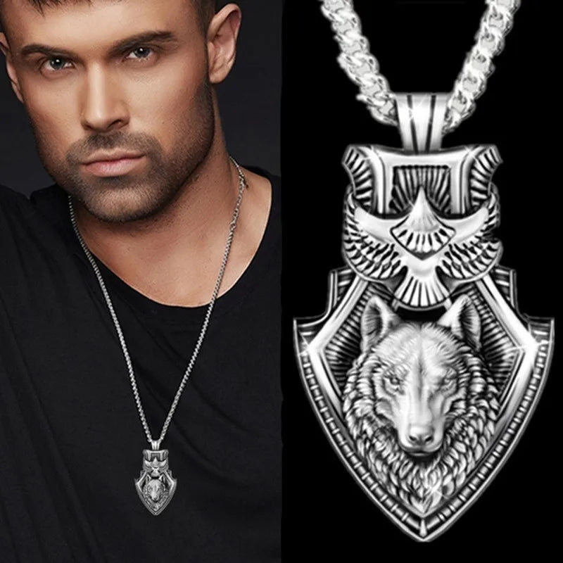 Man wearing a silver necklace with a wolf pendant, close-up of the pendant on a black background