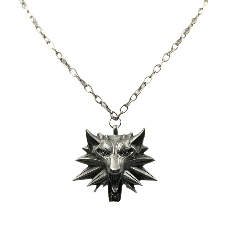 Silver wolf head necklace on a light gray background
