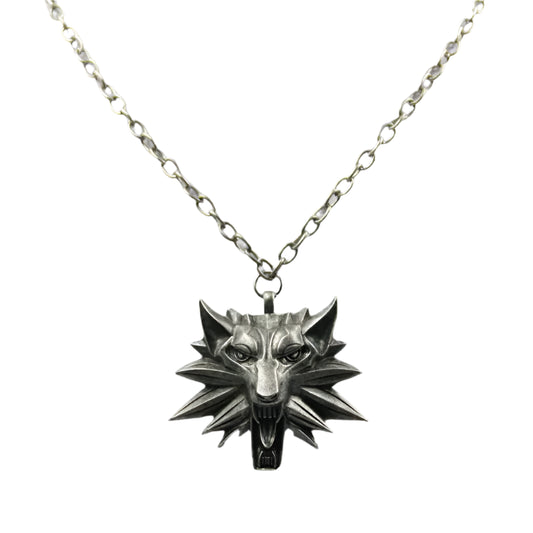 Silver wolf head necklace on a light gray background