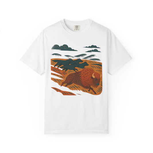 Graphic t-shirt with dynamic wolf pack in motion across grasslands, chasing a bison, printed on soft cotton with relaxed fit and flowing design.