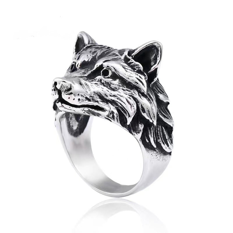 Silver wolf head ring on a white background