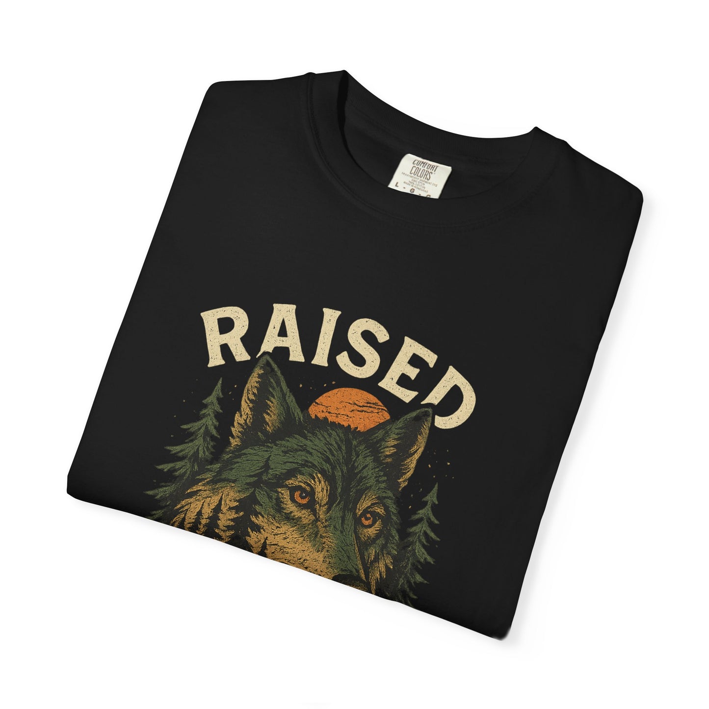 Graphic wolf shirt with rugged wilderness-inspired design and bold “Raised by Wolves” text, printed on soft cotton with relaxed fit.