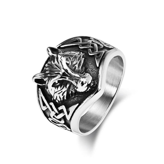 Silver ring with wolf design on a white background