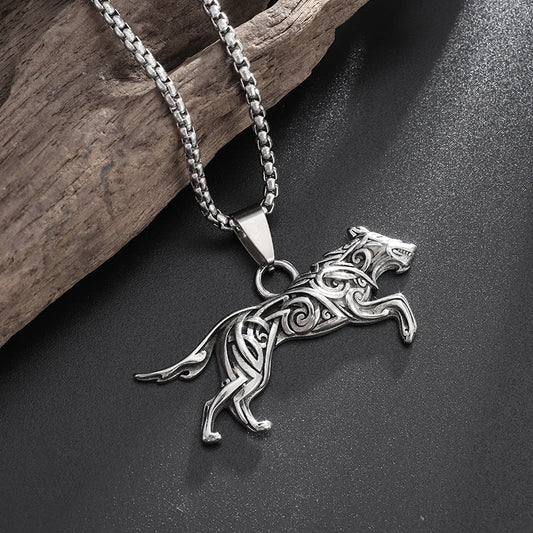 Silver wolf pendant necklace on a dark surface with wooden background