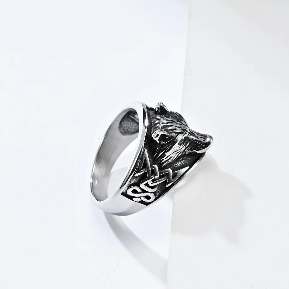 Silver ring with a lion head design on a white background