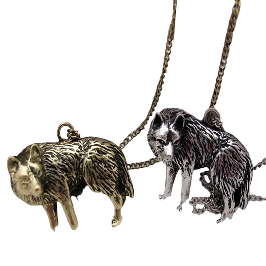 Two wolf-shaped pendants on chains against a white background