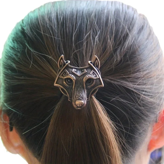Hair bun with a decorative wolf head hair clip on a white background