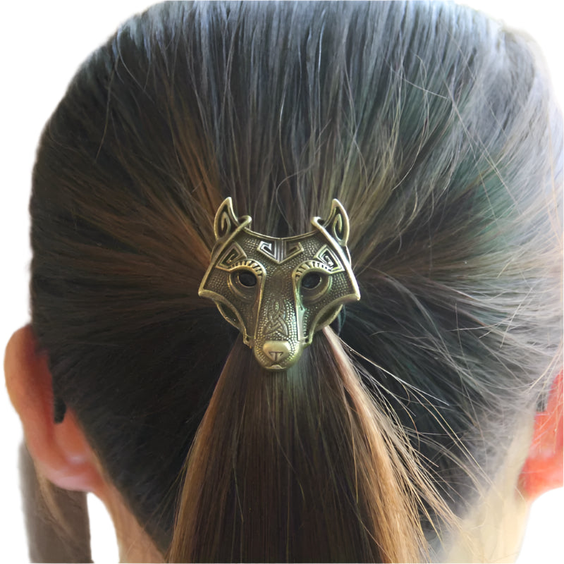 Bronze wolf head hair clip in a person's hair