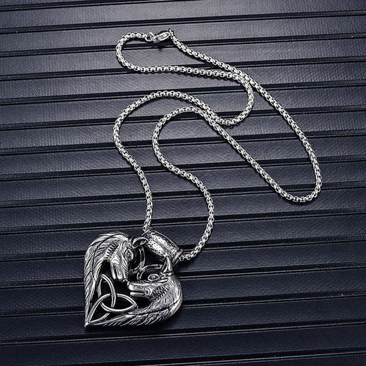Silver necklace with a heart-shaped pendant on a dark textured surface