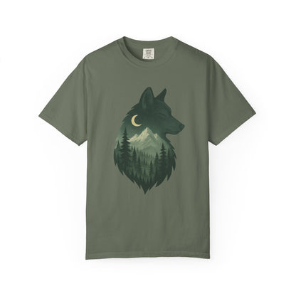 Green T-shirt featuring a serene wolf design surrounded by forest imagery, symbolizing calm strength and deep-rooted nature