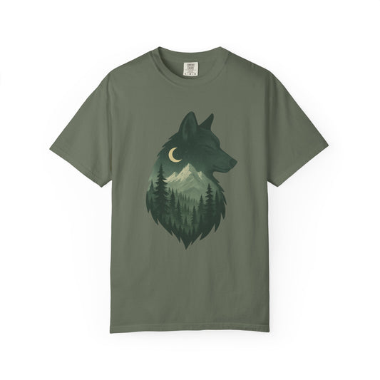 Green T-shirt featuring a serene wolf design surrounded by forest imagery, symbolizing calm strength and deep-rooted nature