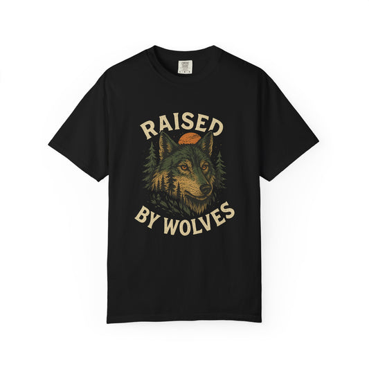 Graphic wolf shirt with rugged wilderness-inspired design and bold “Raised by Wolves” text, printed on soft cotton with relaxed fit.