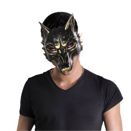 Person wearing a black and gold wolf mask against a white background