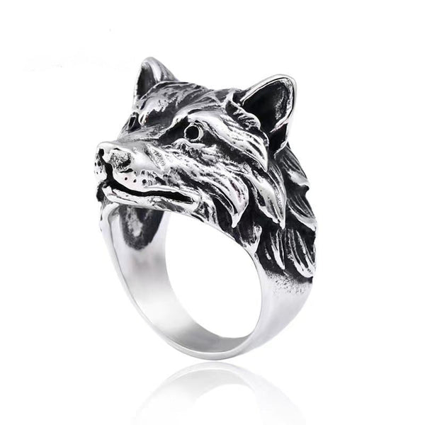Silver wolf head ring on a white background