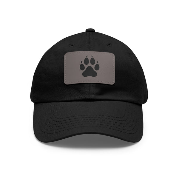 Black cap with a gray patch featuring a wolf paw print on a white background