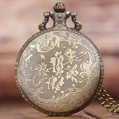Decorative pocket watch with intricate designs on a blurred background