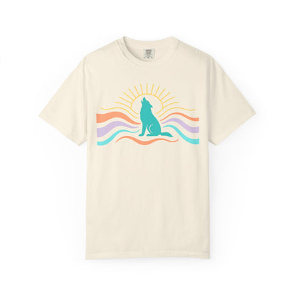 Beige t-shirt with a colorful graphic of a wolf howling at the sun on a white background