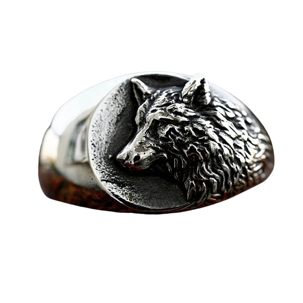 Silver wolf head ring on a white background