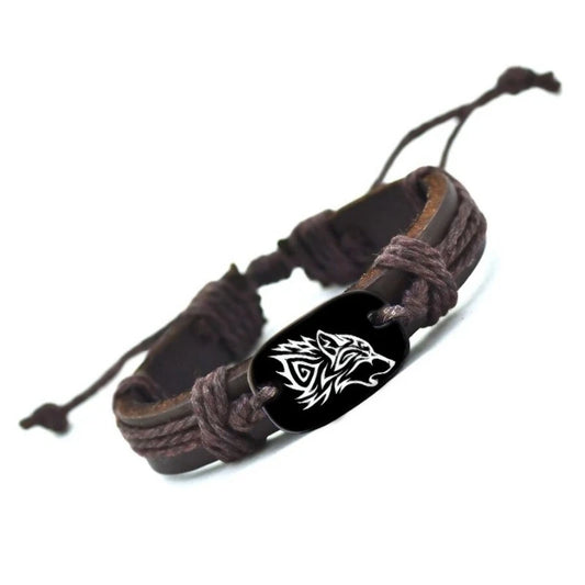 Brown braided leather bracelet with a black tag featuring a wolf design on a white background