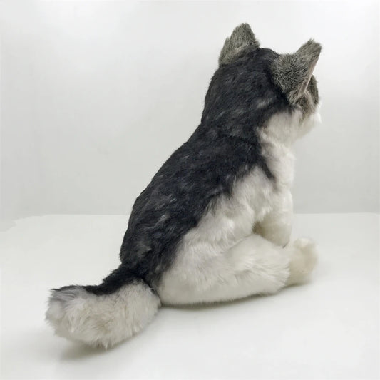 Plush toy resembling a gray and white wolf on a white background