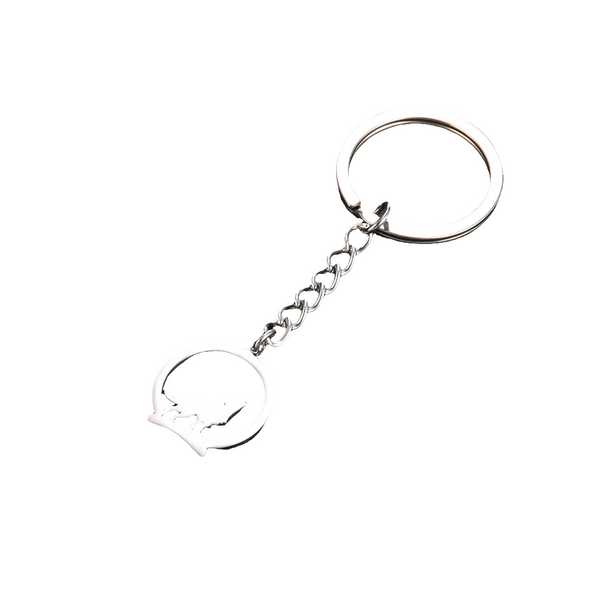 Silver keychain with a howling wolf design on a white background