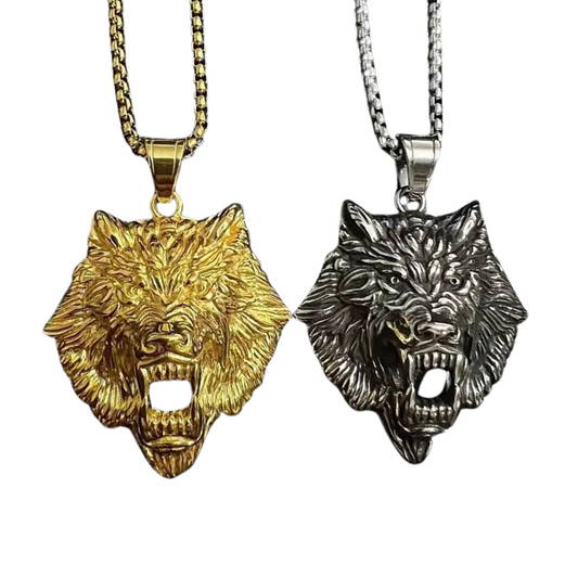Two wolf head pendants, one gold and one silver, on white backgrounds.