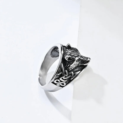 Silver ring with a lion head design on a white background