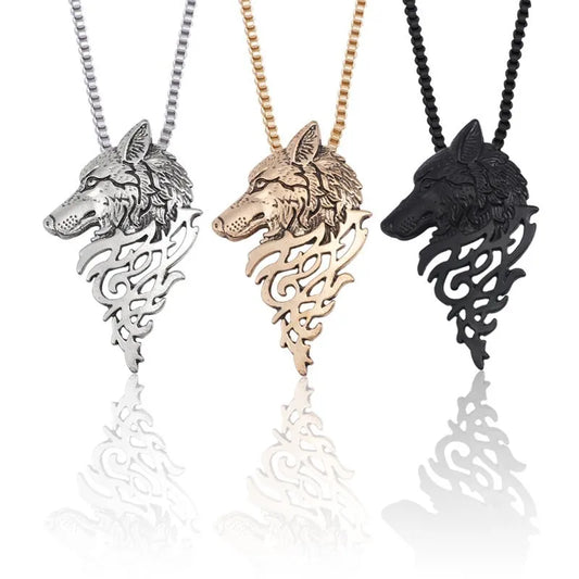 Three wolf head pendants in silver, gold, and black on white background