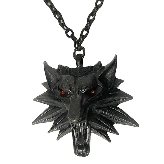 Black wolf head pendant on a chain against a white background